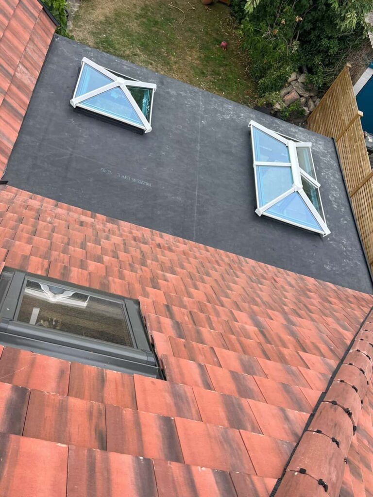This is a photo taken from the roof ridge looking down a tiled pitched roof on to a flat roof. Works carried out by TRP Roofing South Cave