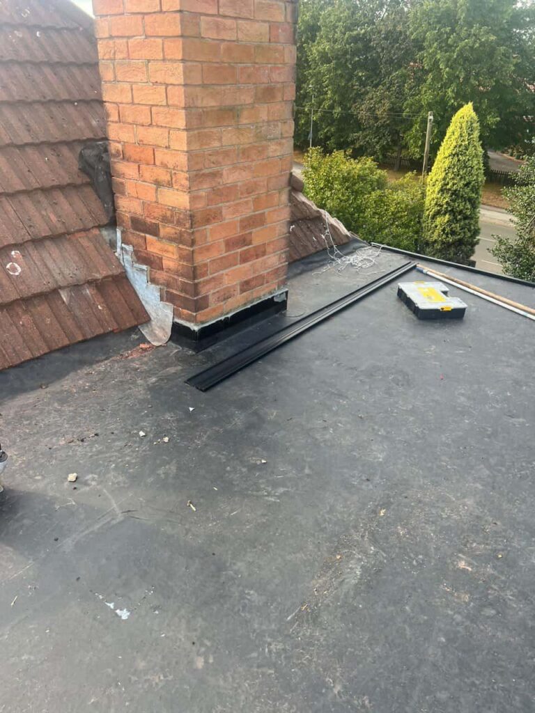 This is a photo of a flat roof which has just been repaired, there is also a chimney stack and some leadwork has also been dressed. Works carried out by TRP Roofing South Cave