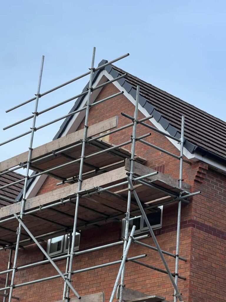 This is a photo of a roof which has just been repaired. There is a scaffold located at the gable end for access onto the roof. Works carried out by TRP Roofing South Cave